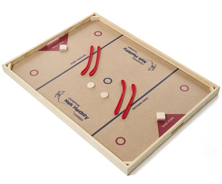 Overhead view of a large nok hockey table with 4 puck and 4 hockey sticks.