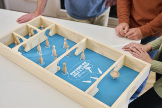 Skittles board game in play while top is spinning.